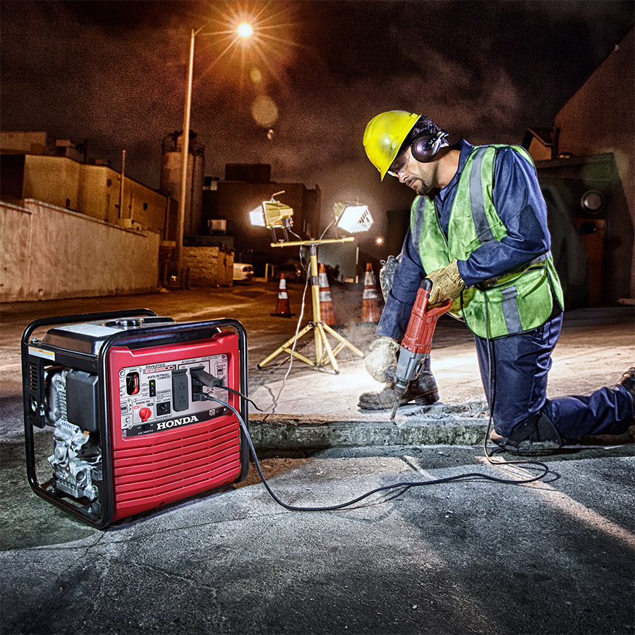 Man piercing concrete with a Honda EB2800i Generator